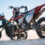 selective focus photography of two white and black dualsport motorcycles